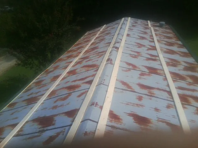 Rusted metal roof panels with new wood purlins before replacement — Storm Damage Roof Repair in Theodore by Roofing Brothers